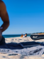 A sunny beach scene with a pair of stylish Solvista sunglasses resting on a colorful towel.