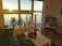 Cozy living room with large windows overlooking Lake Tahoe at sunrise.