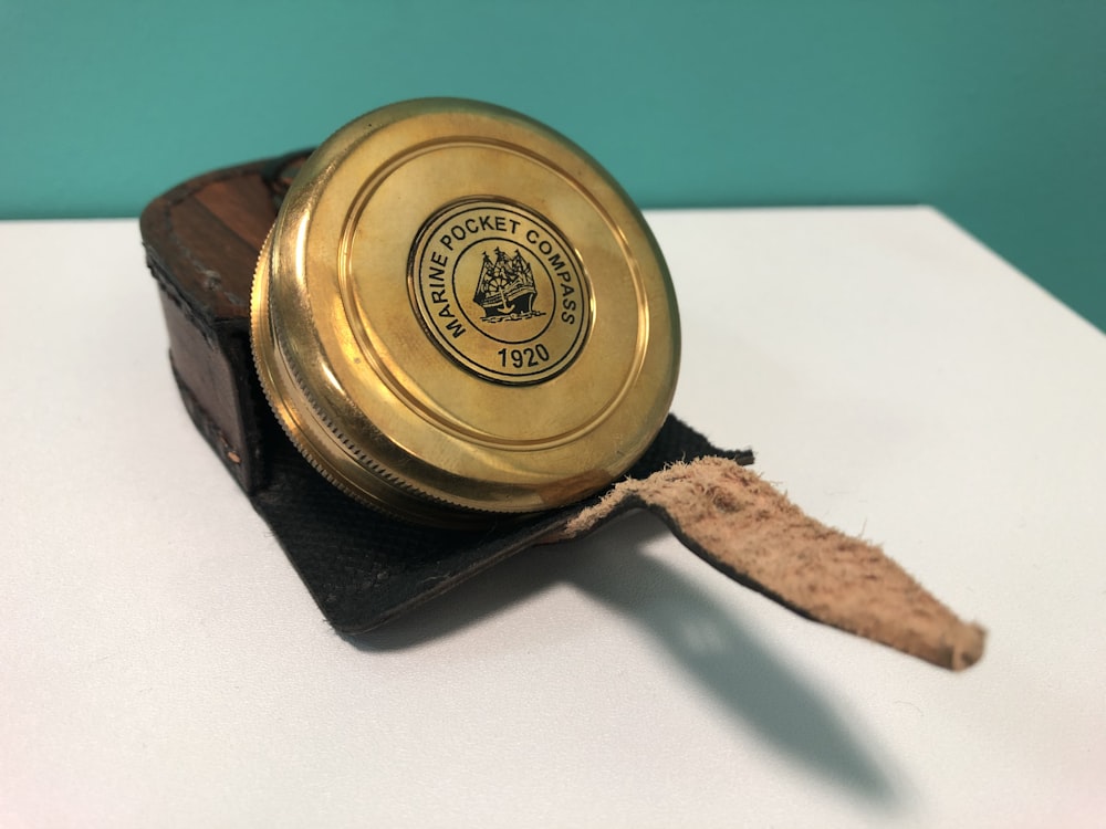 gold and black round container