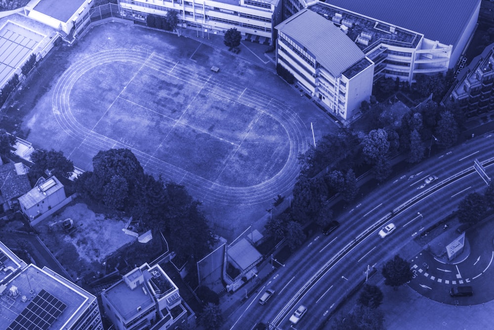 aerial view of green field surrounded by trees