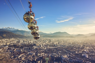 yellow and black cable car over city during daytime