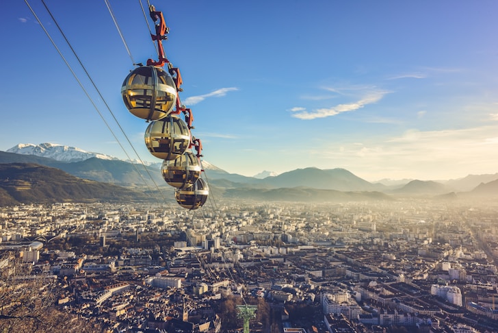 yellow and black cable car over city during daytime
