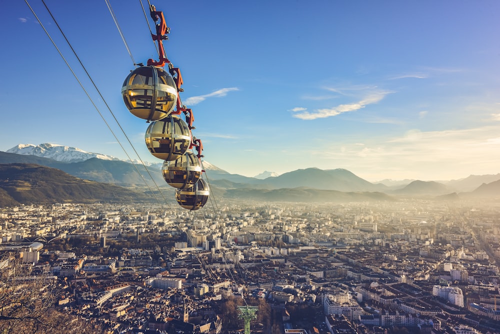 yellow and black cable car over city during daytime