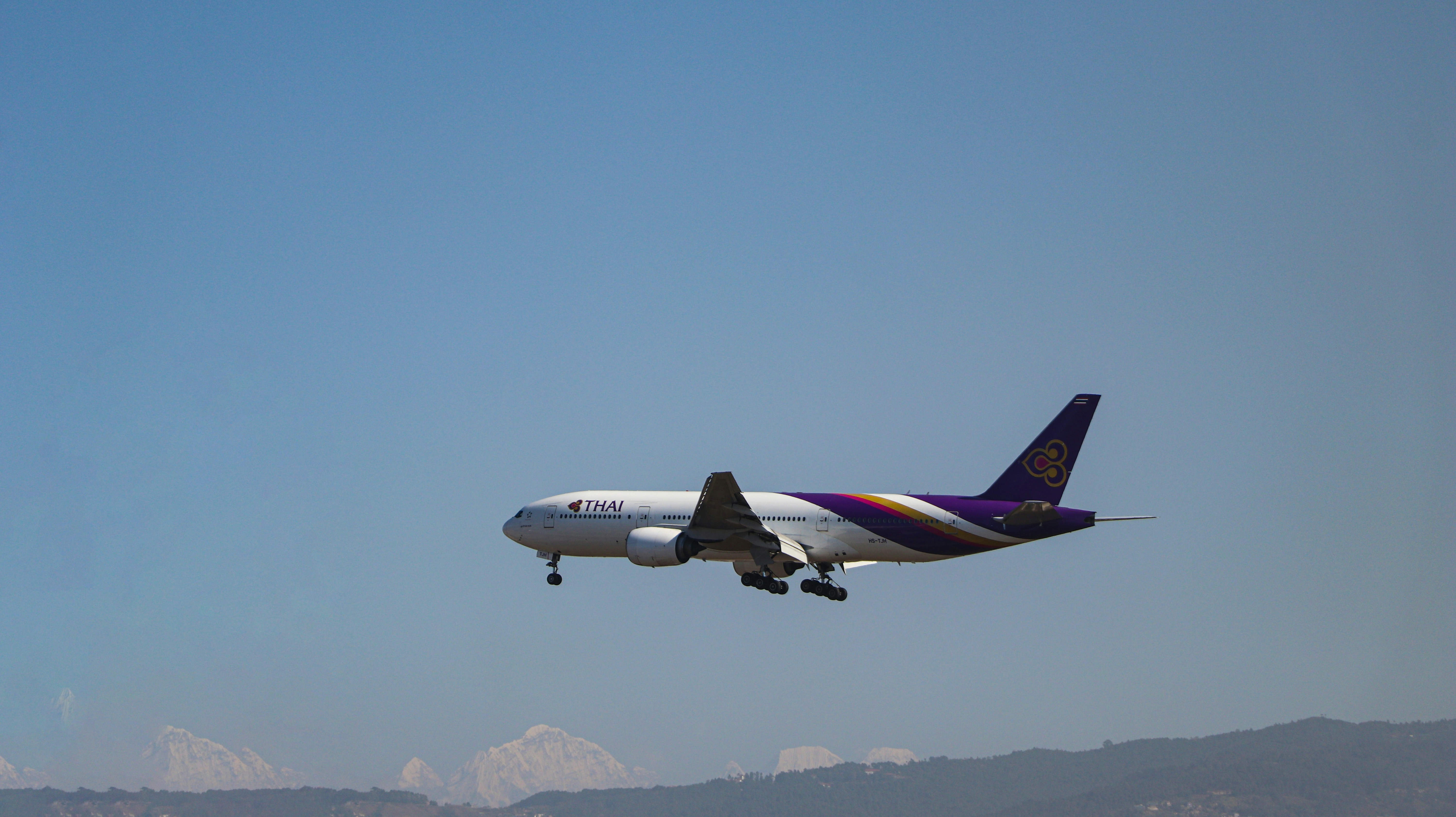 white and red air plane flying over the city during daytime, Flying Airplane 