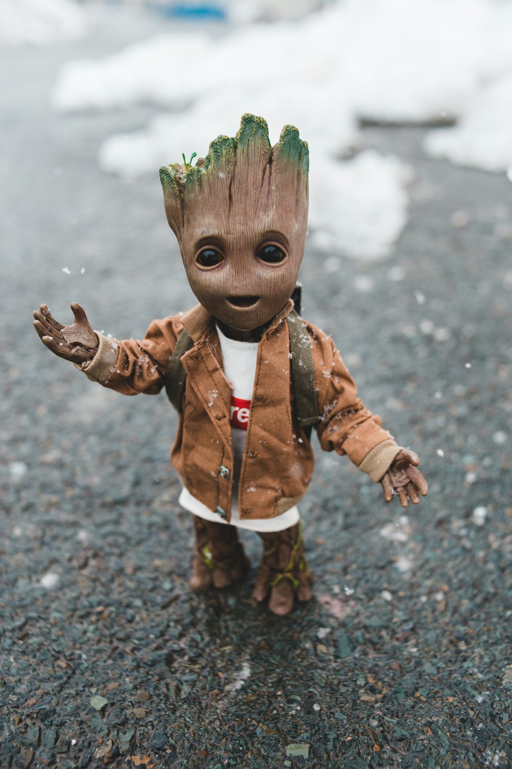 boy in brown jacket with green paint on face