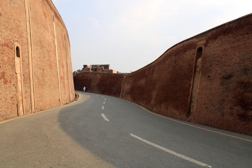 brown brick wall near road