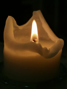 Large recycled crayon candle with multiple colors melting gently, creating a cozy atmosphere.