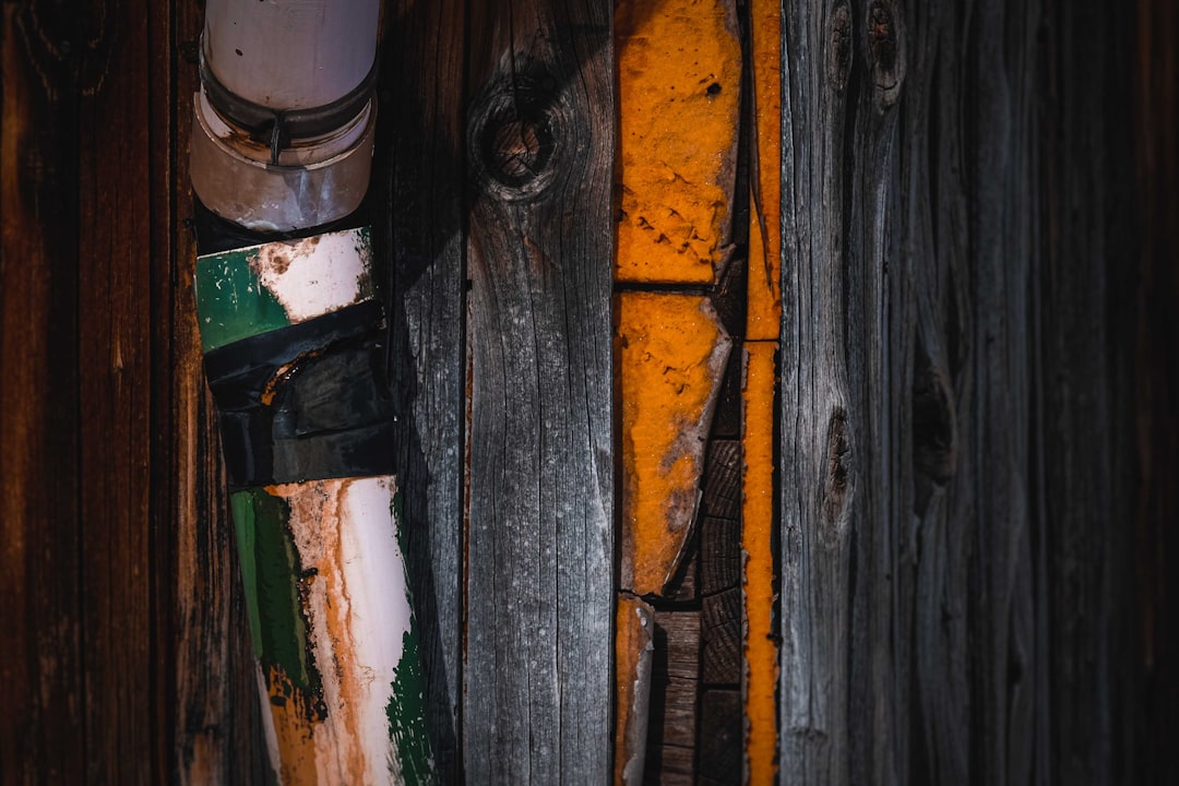 brown wooden plank with green and white paint