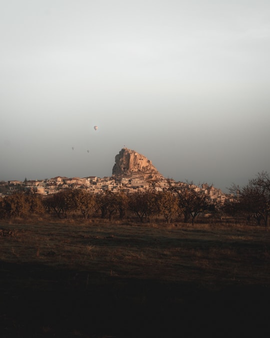 brown mountain under white sky during daytime in Uçhisar Turkey