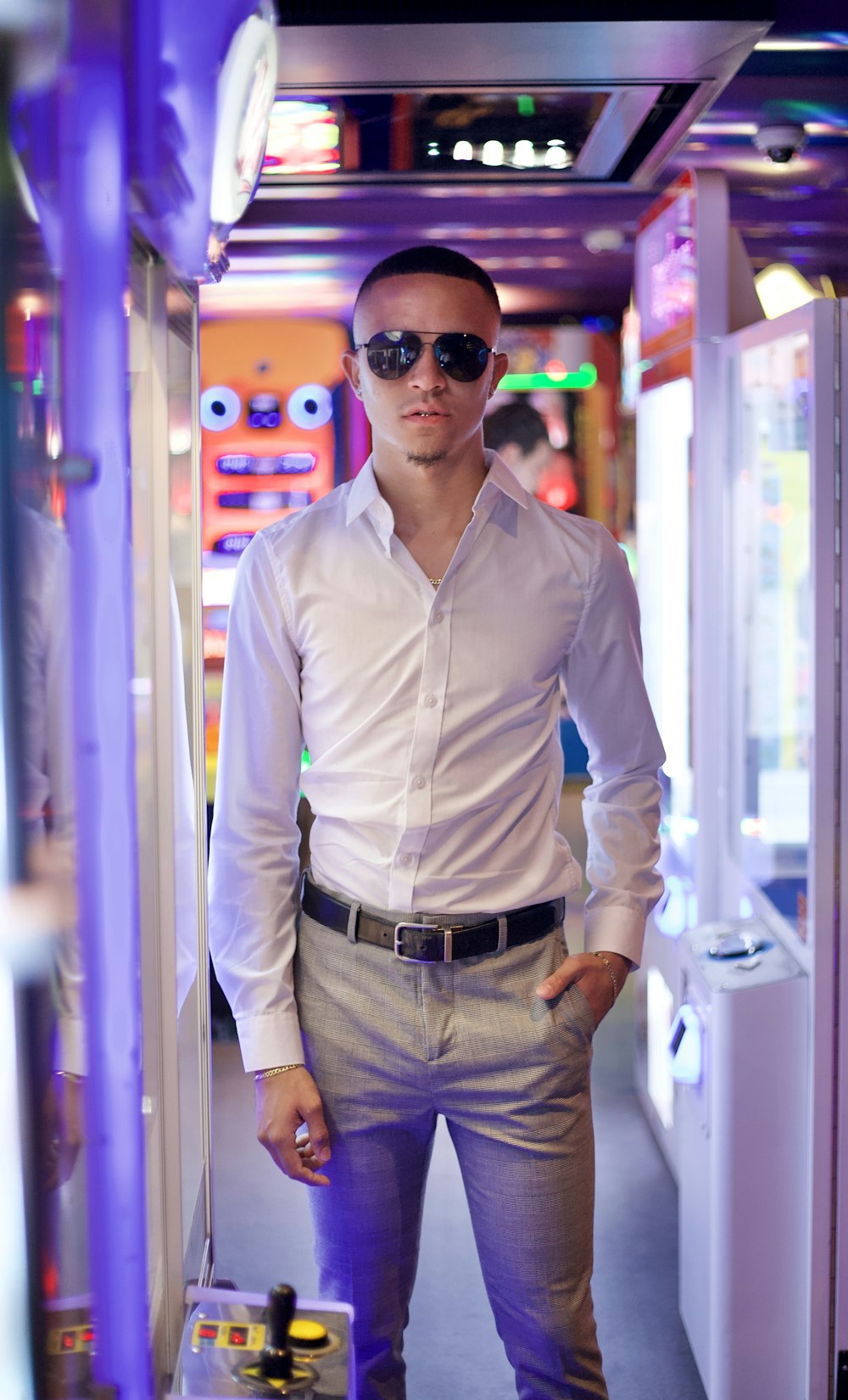 man in white dress shirt and brown pants wearing black sunglasses