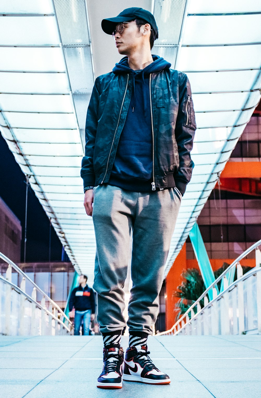 Man in blue denim jacket and blue denim jeans standing on white bridge  during daytime photo – Free Apparel Image on Unsplash