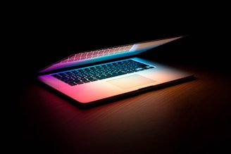 macbook pro on brown wooden table