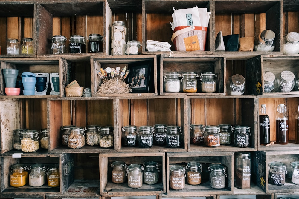 brown wooden shelf with assorted spices