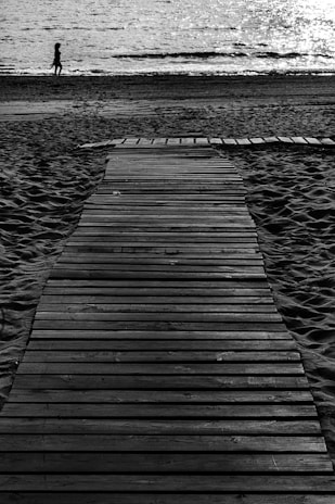 grayscale photo of wooden dock