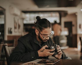 solopreneur man in black jacket using camera