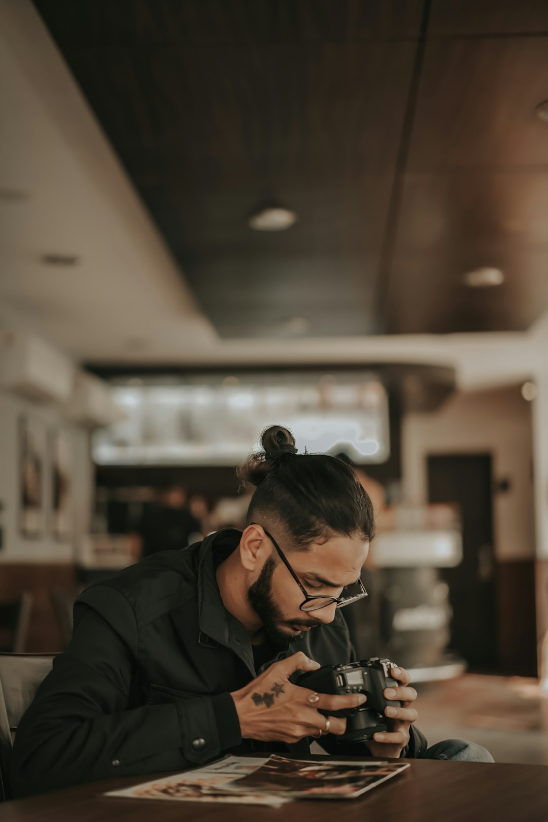 man in black jacket using smartphone