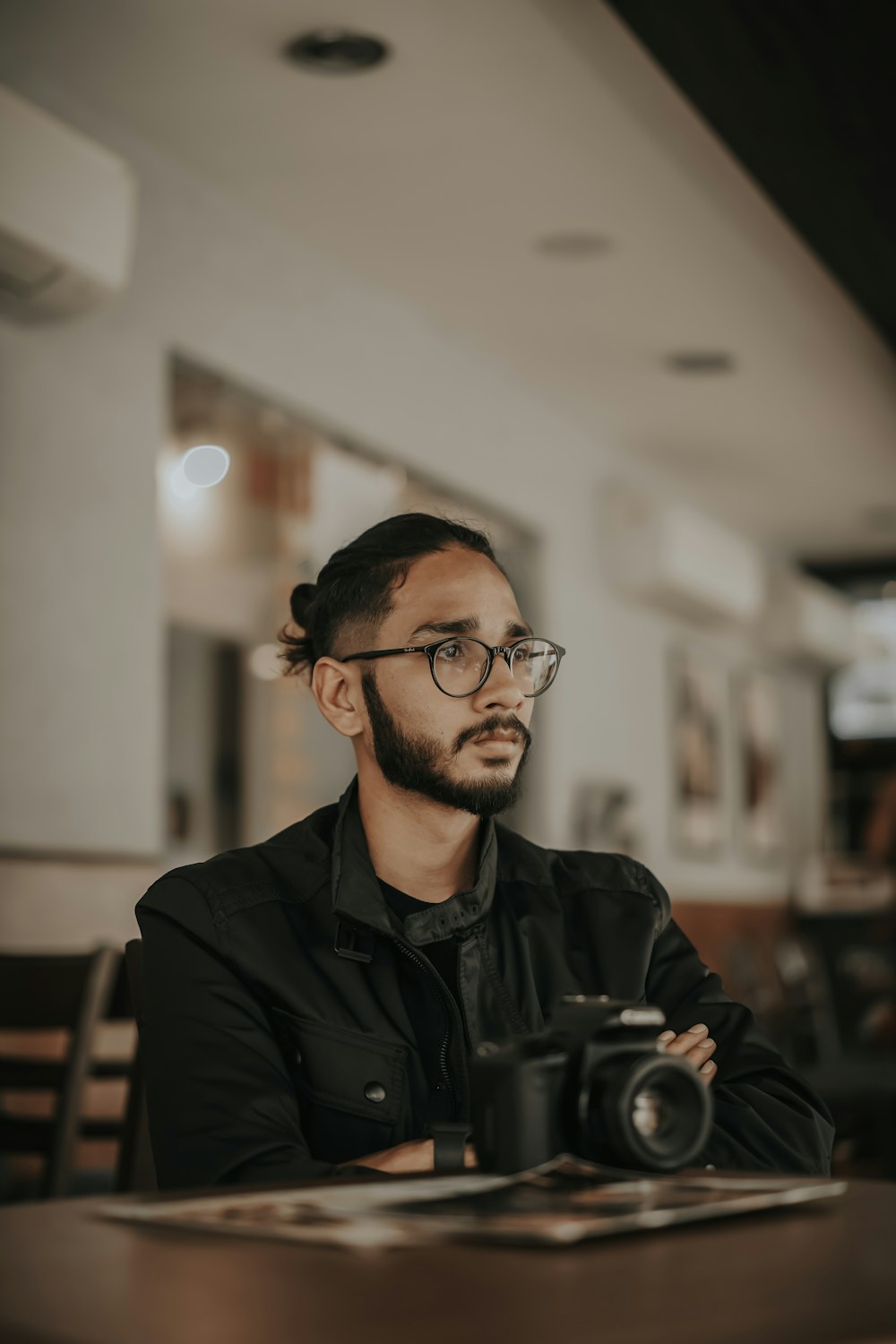 man in black leather jacket wearing black framed eyeglasses