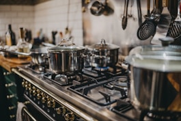 stainless steel cooking pots on gas stove