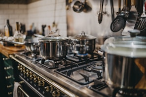 stainless steel cooking pots on gas stove
