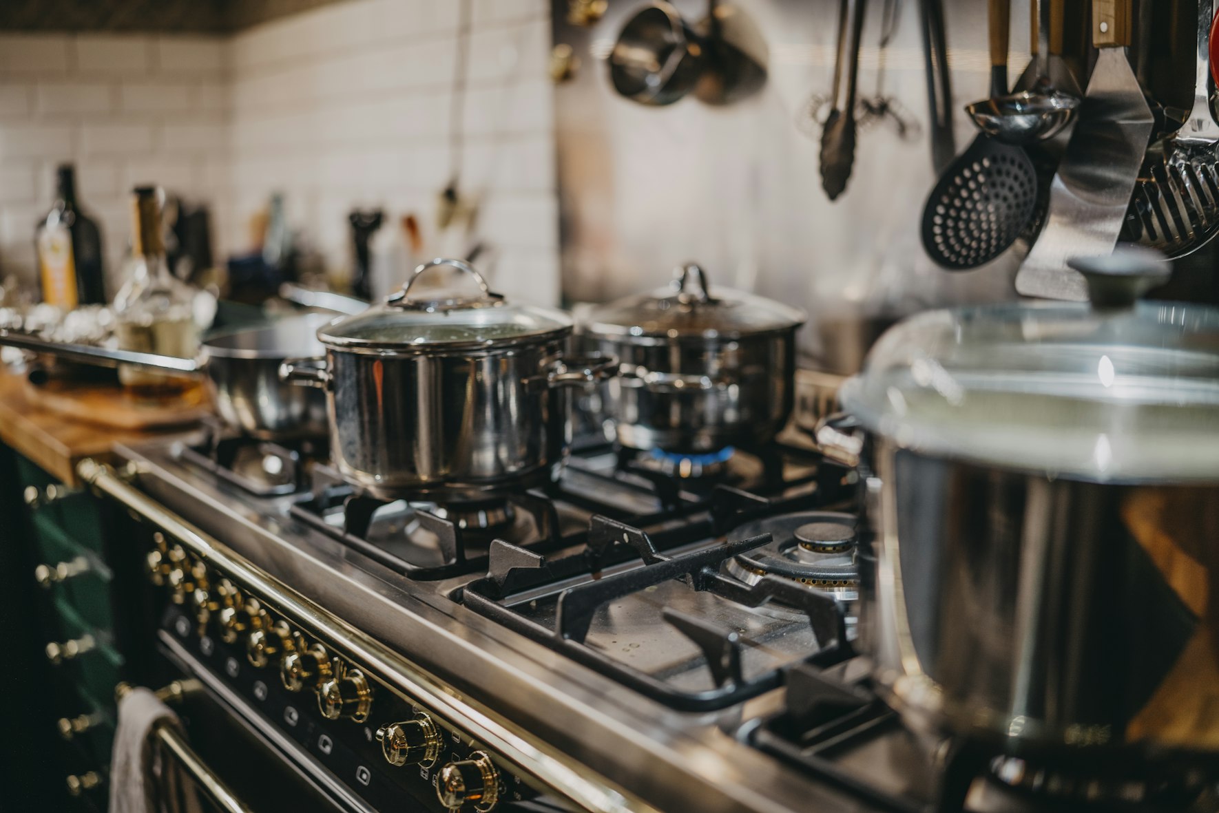 A gas stove with pots and pans heating.