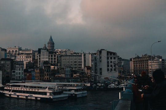 white and brown concrete building near body of water during daytime in Galata Tower Turkey