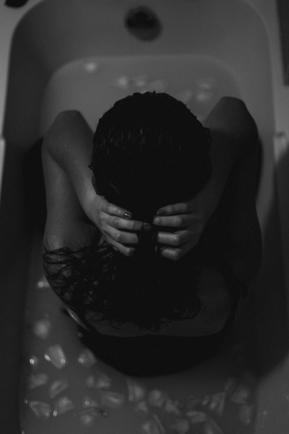 topless man in bathtub with water