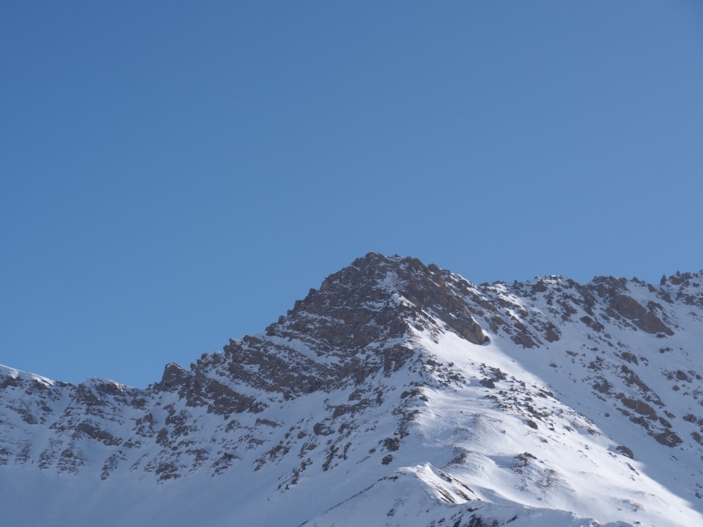 snow covered mountain under blue sky during daytime