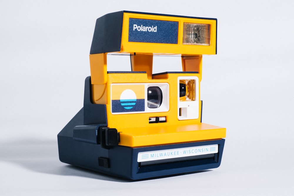 yellow and black polaroid instant camera