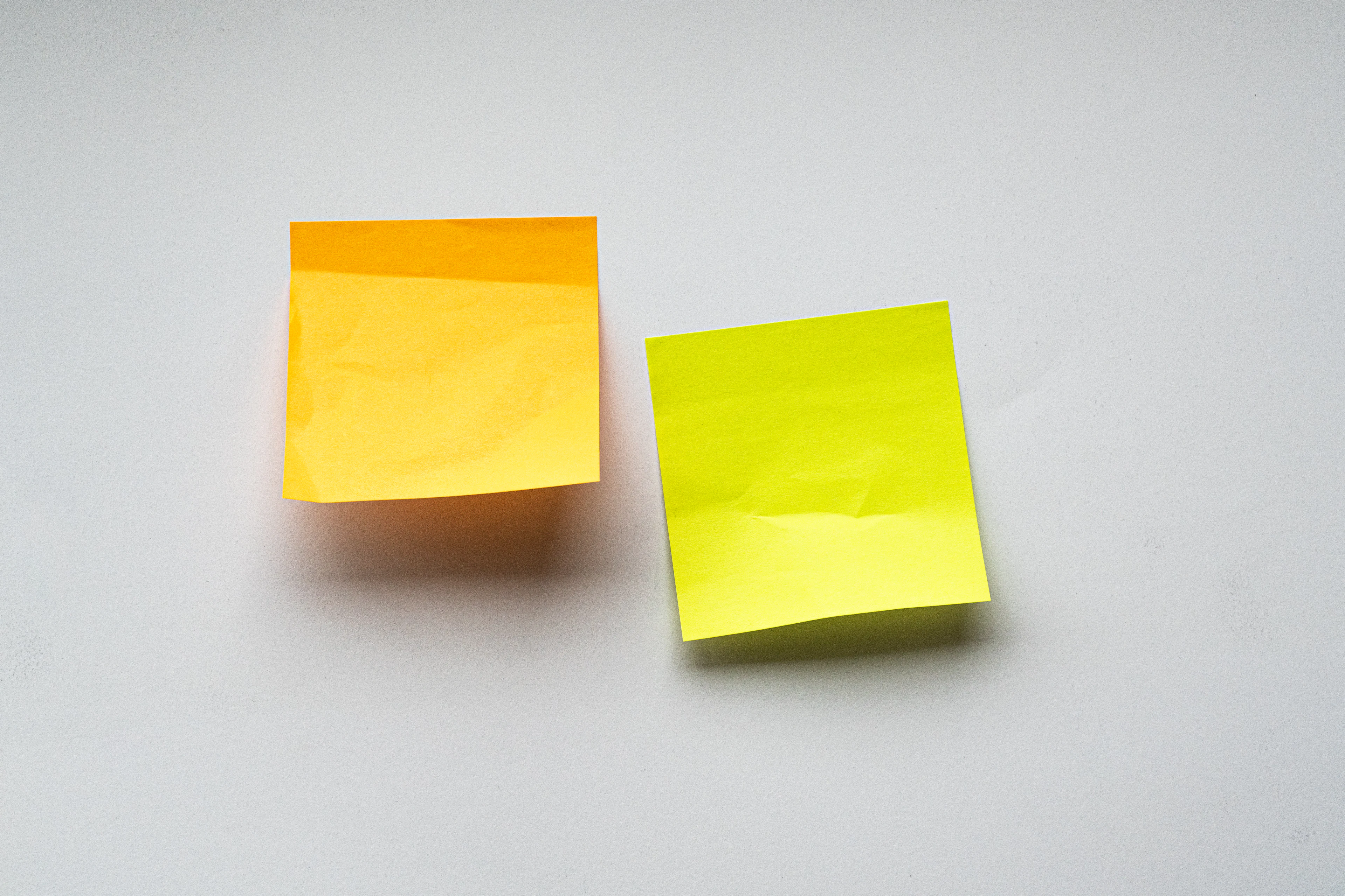 Sticky notes arranged across a wall during a workshop