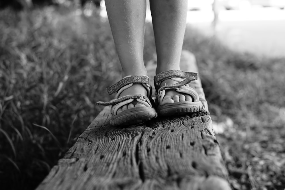 grayscale photo of person wearing sandals