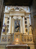 A serene altar adorned with candles and a statue of the Virgin Mary during a liturgical ceremony.