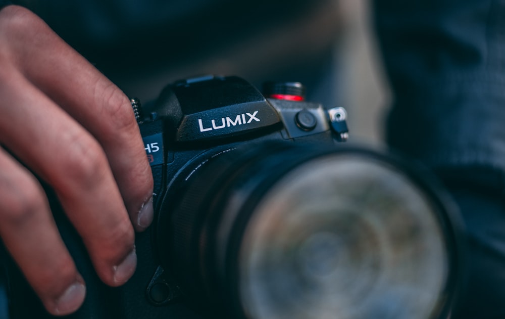 black nikon dslr camera on persons hand