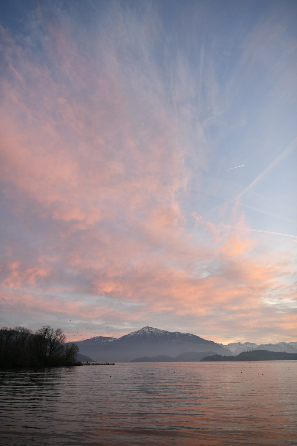 silhouette of mountain under cloudy sky during daytime