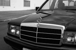 An old photograph of a legendary car brand’s first factory bustling with workers.