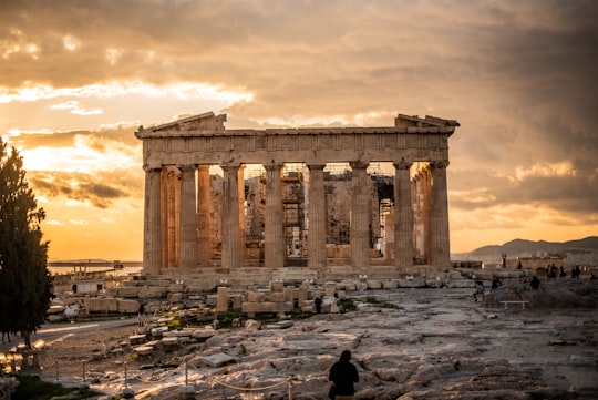 people walking near brown concrete building during daytime in Parthenon Greece