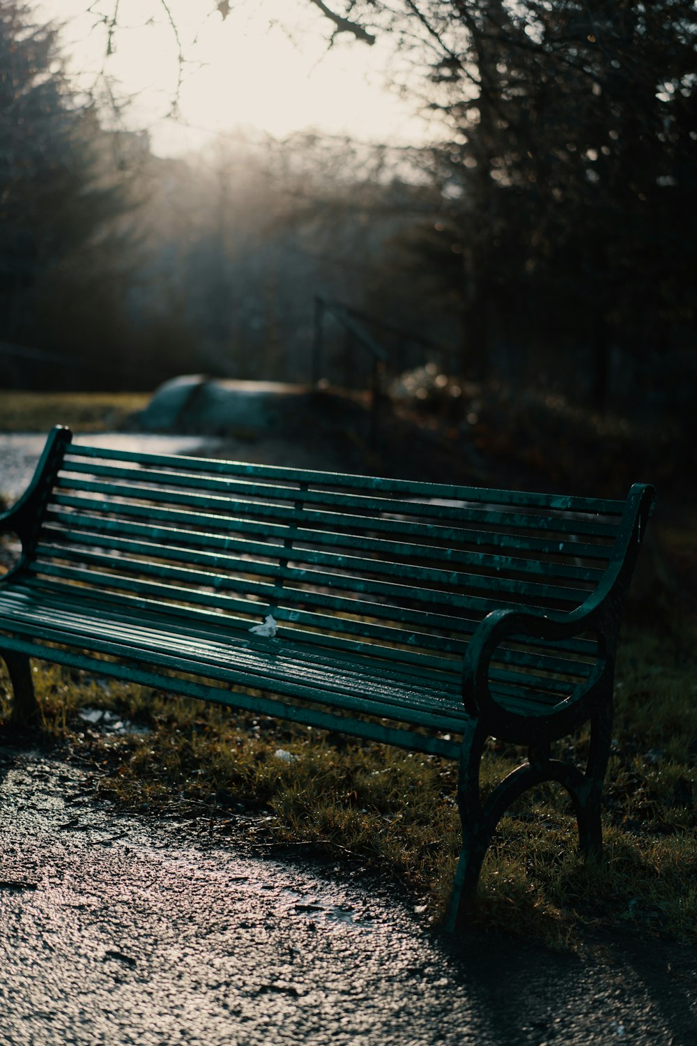 black metal bench on gray ground