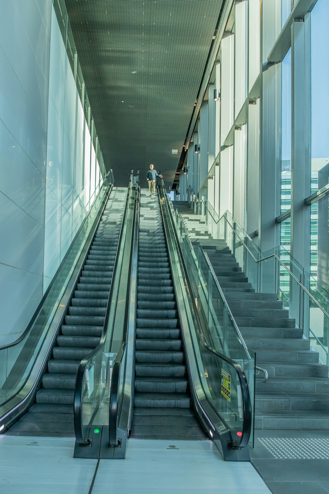 stainless steel escalator in white room