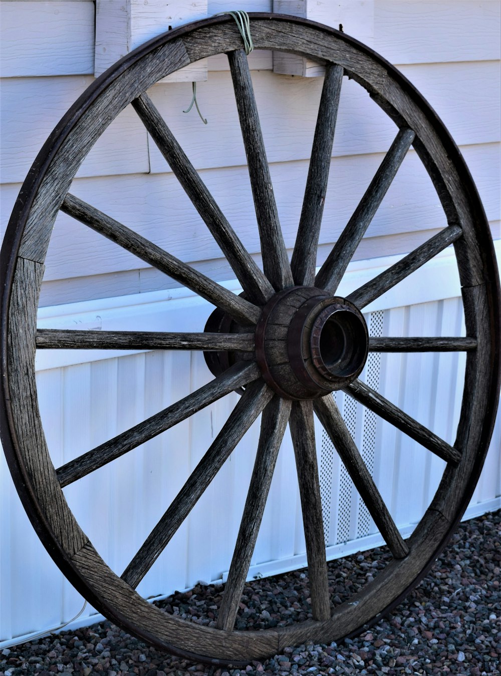 brown wooden wheel on gray concrete floor