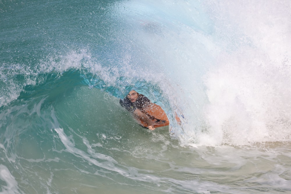 person surfing on sea waves during daytime