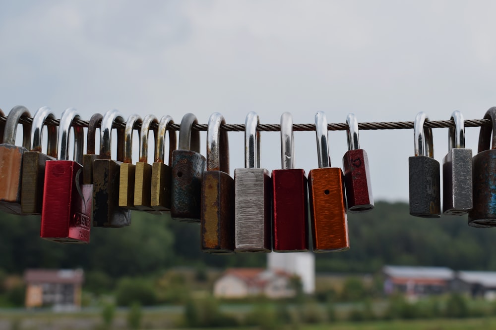 red and brown padlock on gray metal wire