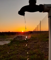 person holding black string during sunset