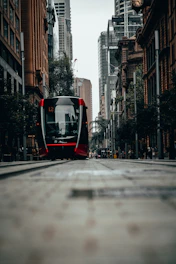 A modern tram navigating through a bustling European city street, showcasing smooth integration with urban infrastructure.