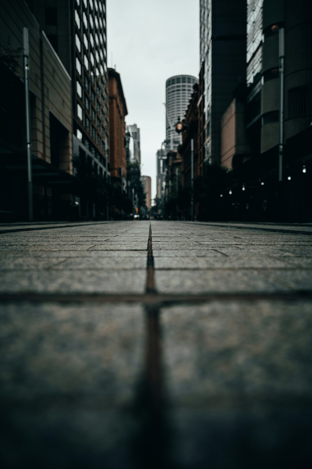 gray concrete road between high rise buildings during daytime