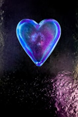 purple heart shaped ornament on black and white textile