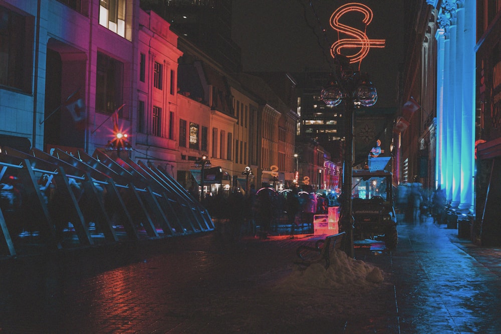 cars on road near buildings during night time