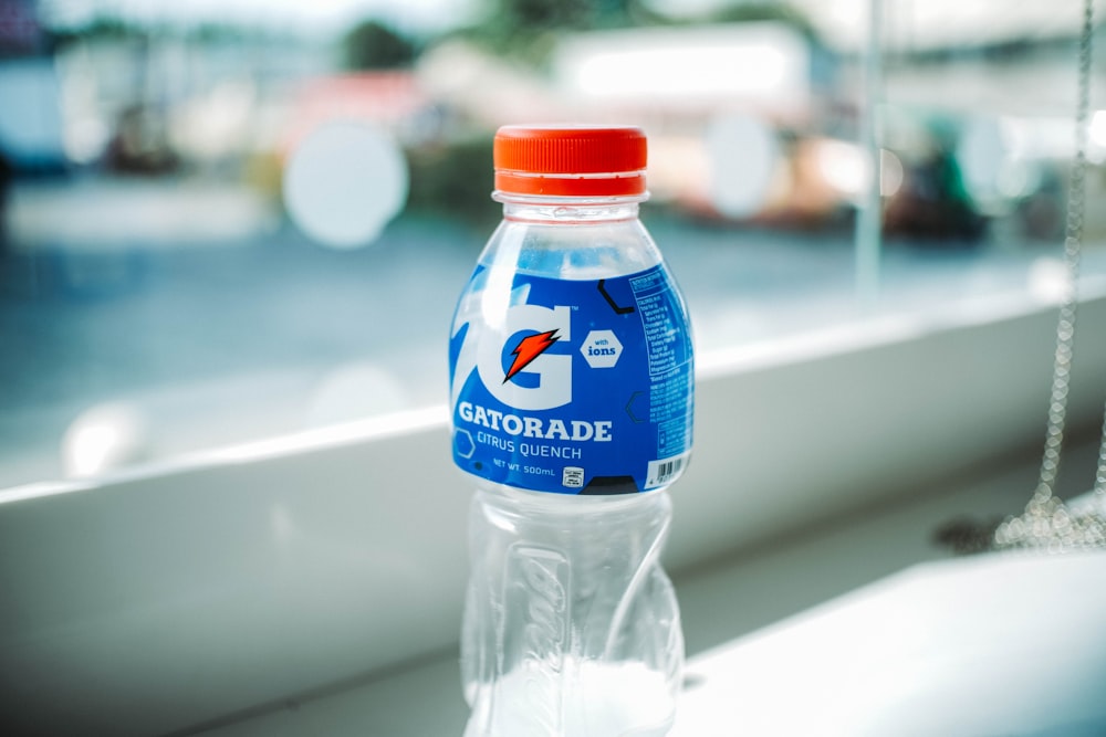 blue labeled plastic bottle on white table