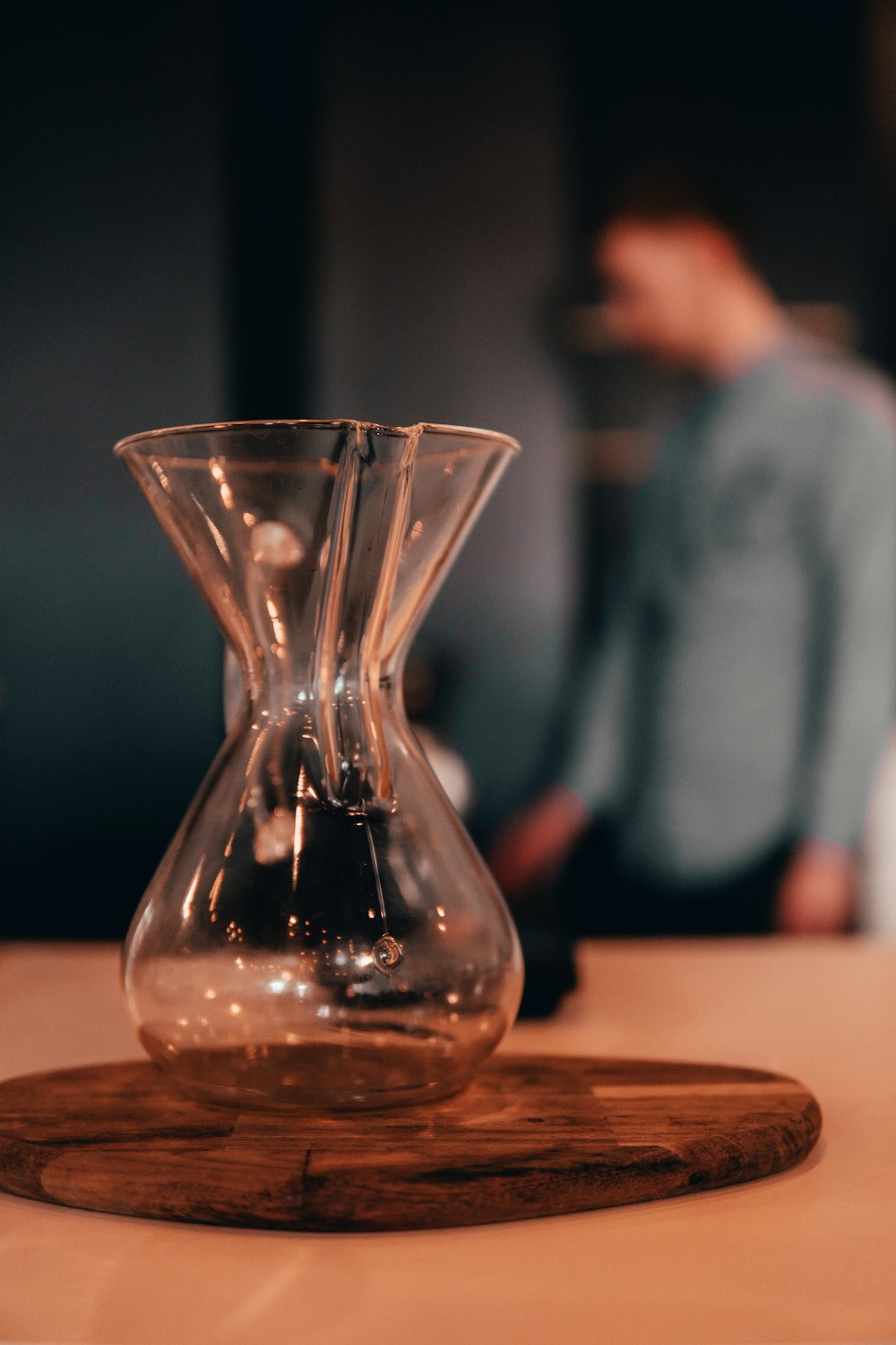 clear glass vase on brown wooden table