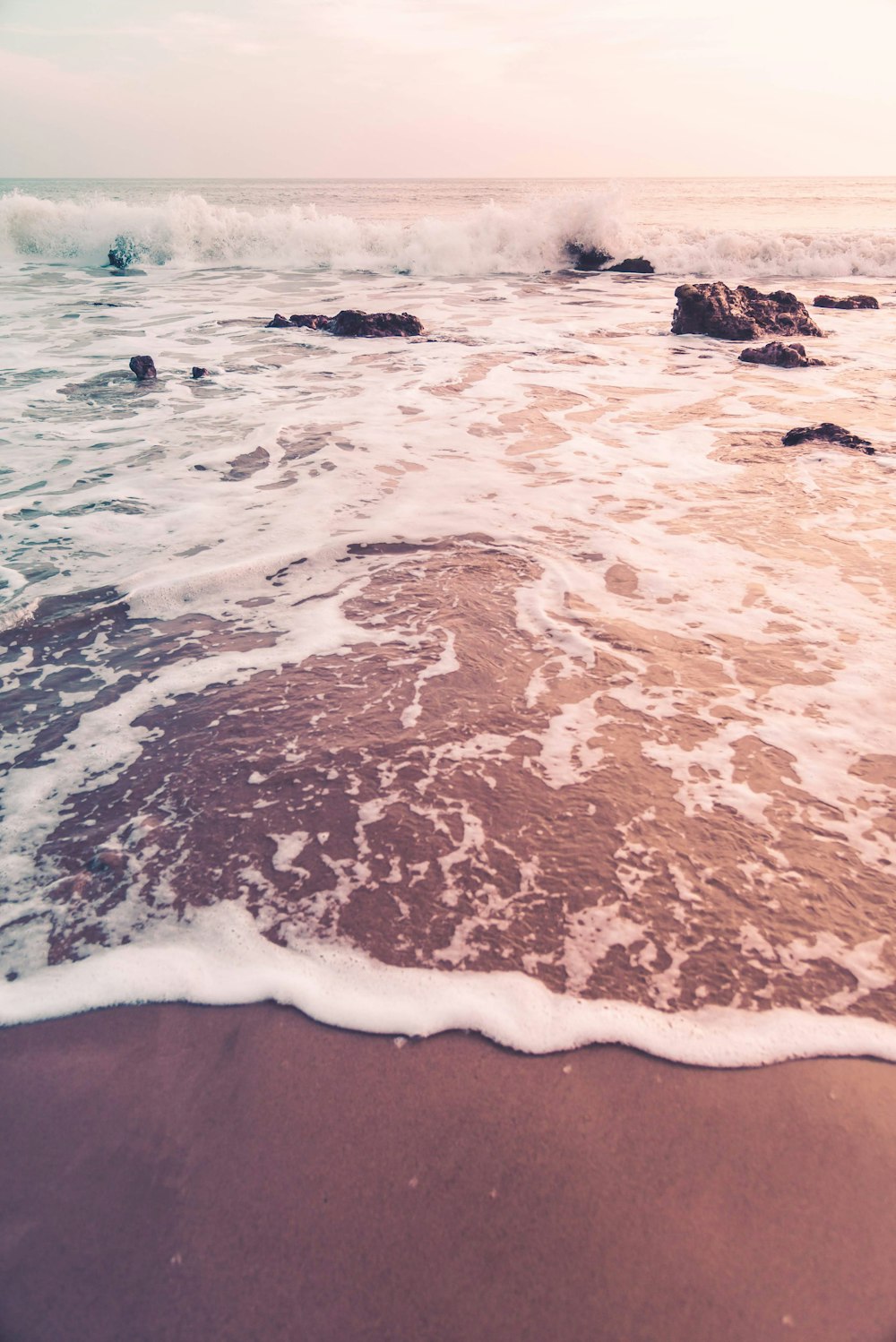 ocean waves crashing on shore during daytime