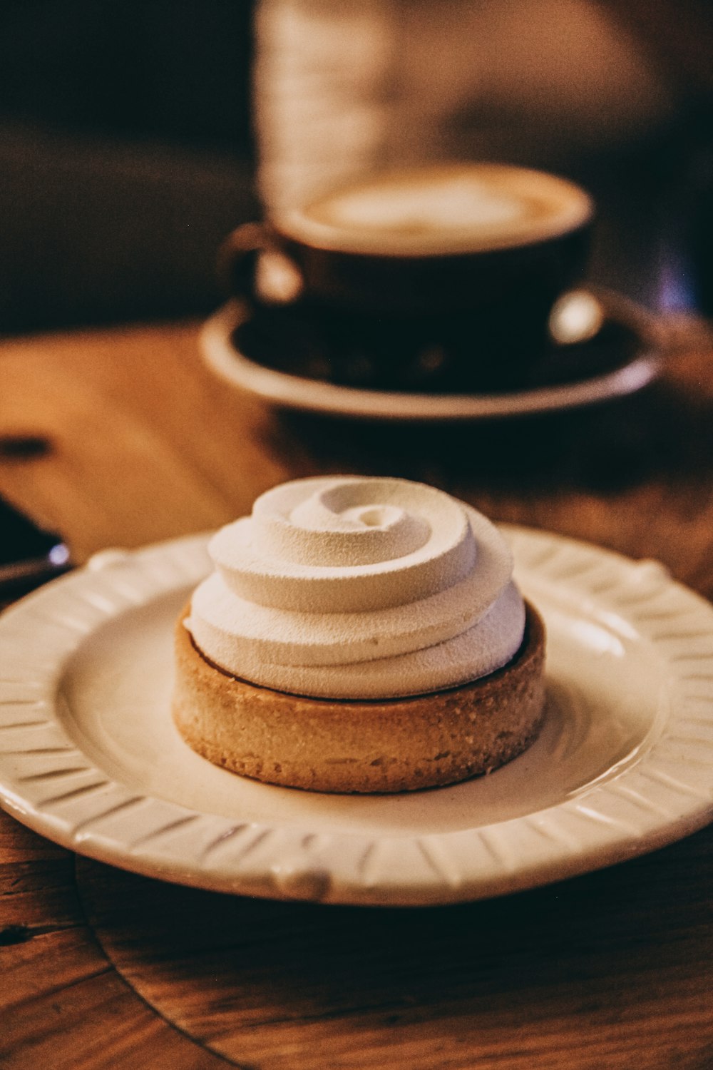 brown and white cupcake on white ceramic plate