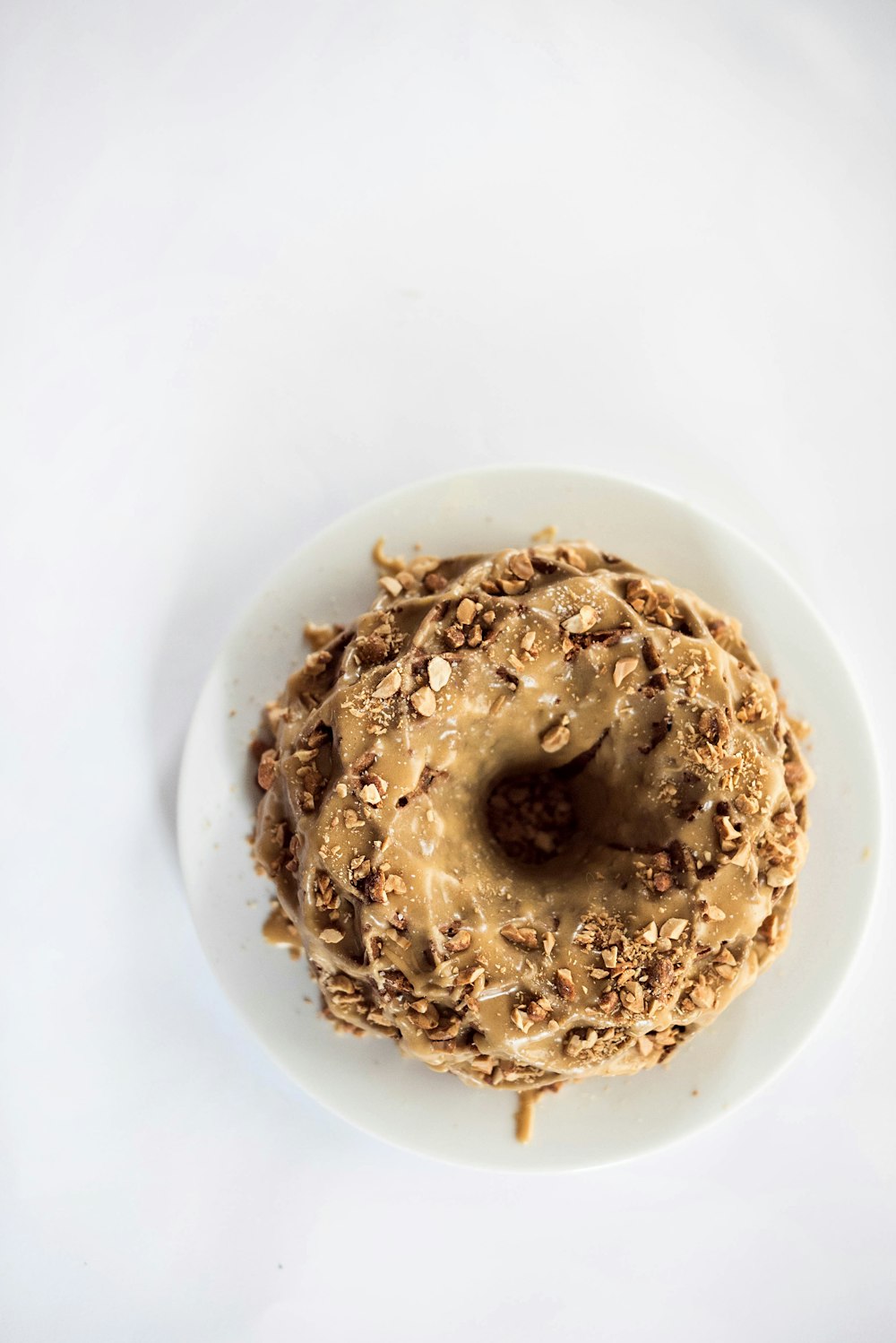 brown doughnut on white ceramic plate